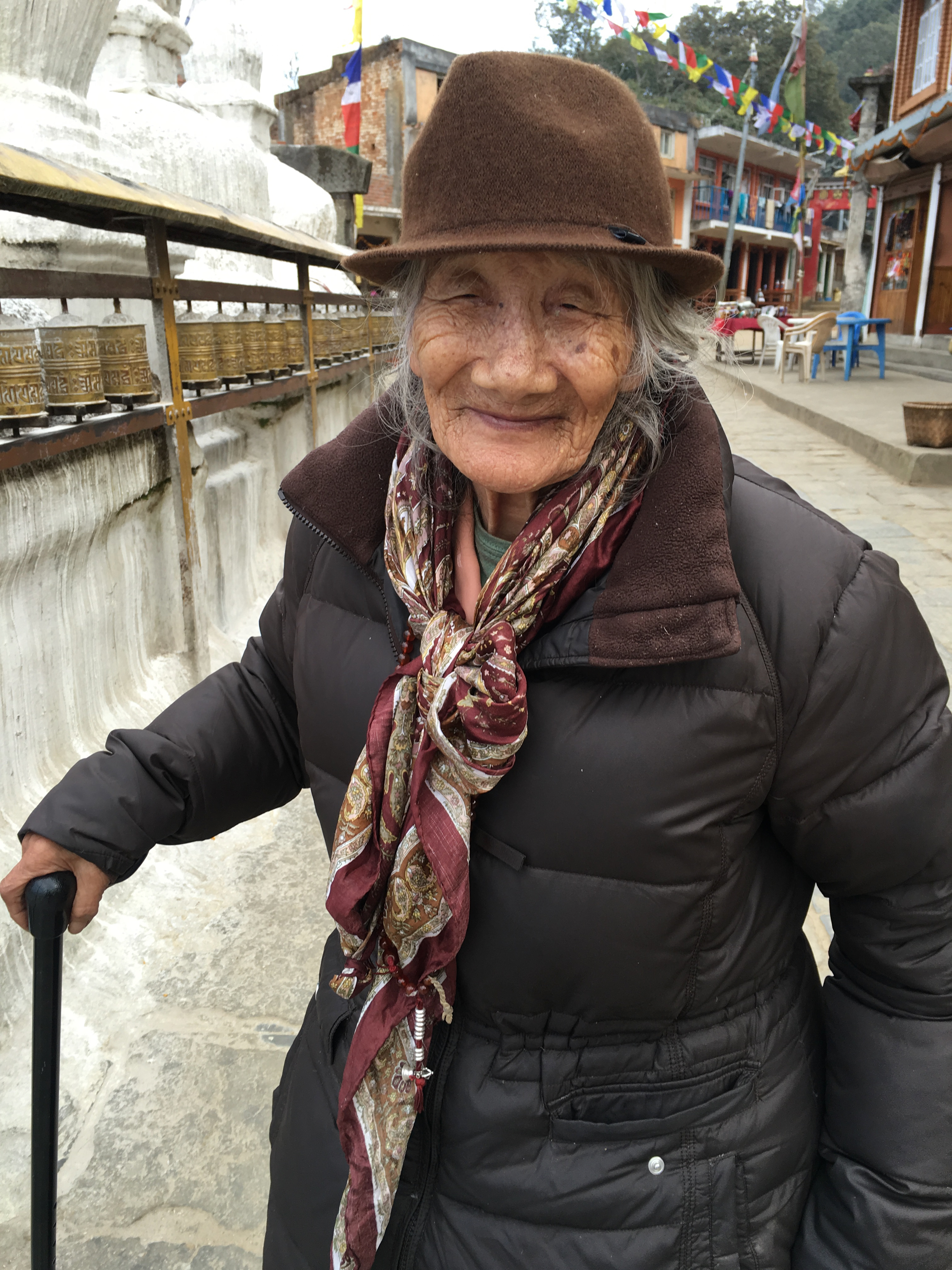 Ama-la in Nepal with prayer wheels