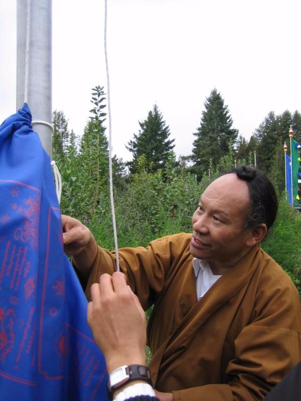 Rinpoche_Raising_Prayer_Flags.jpg